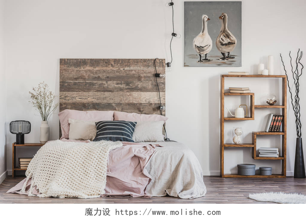 现代卧室内部的大床和装饰物可爱的海报与两只鸭子在有品味的卧室内部的白色墙壁与床与柔和的粉红色床上用品